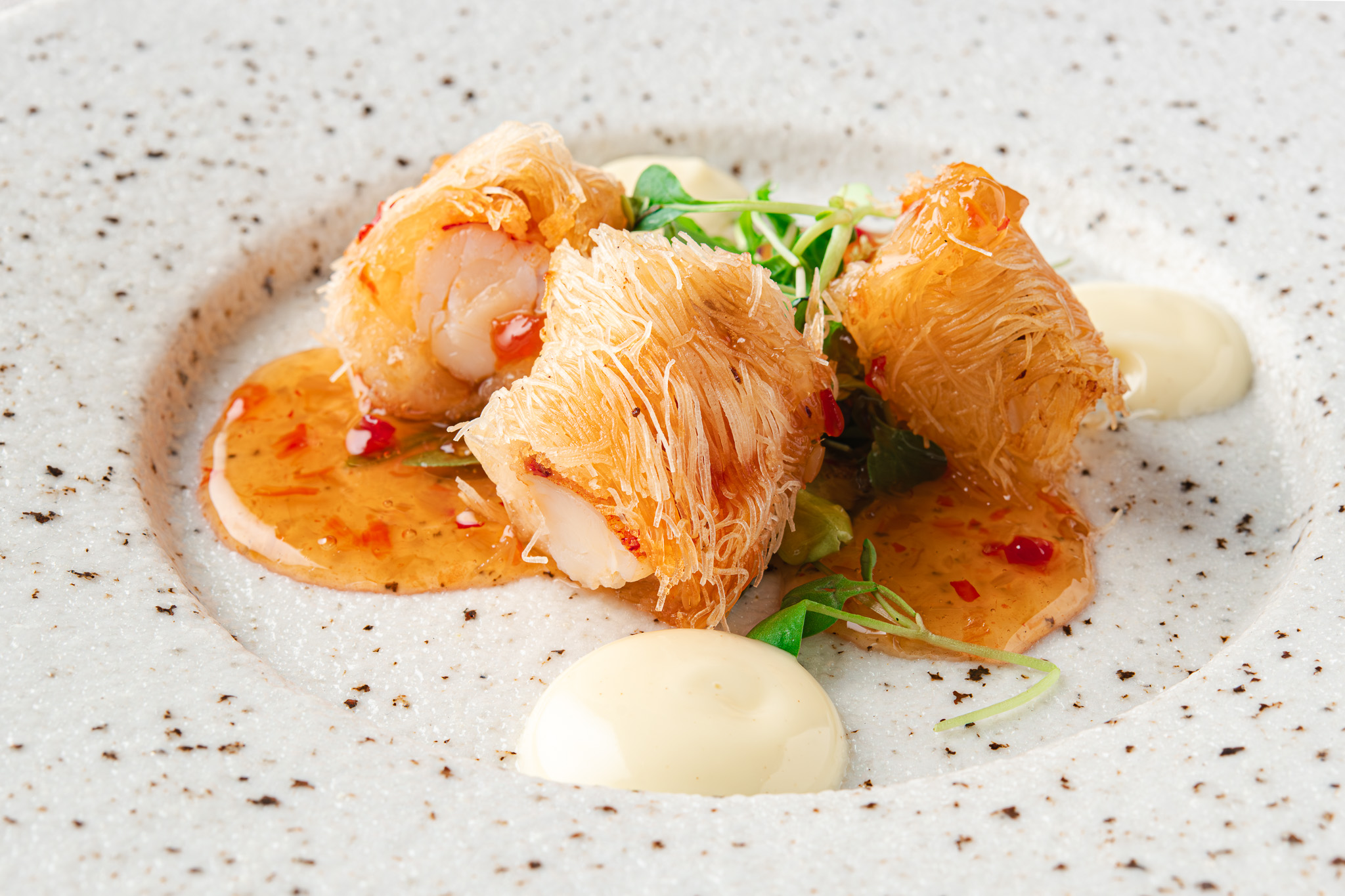Plant-based course plated on a black round plate