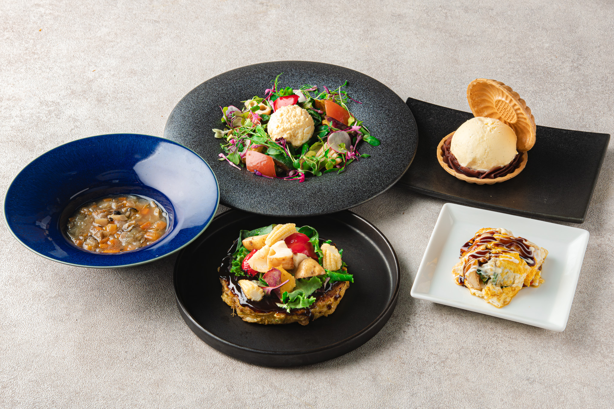 Course spread highlighting steak and plated dishes