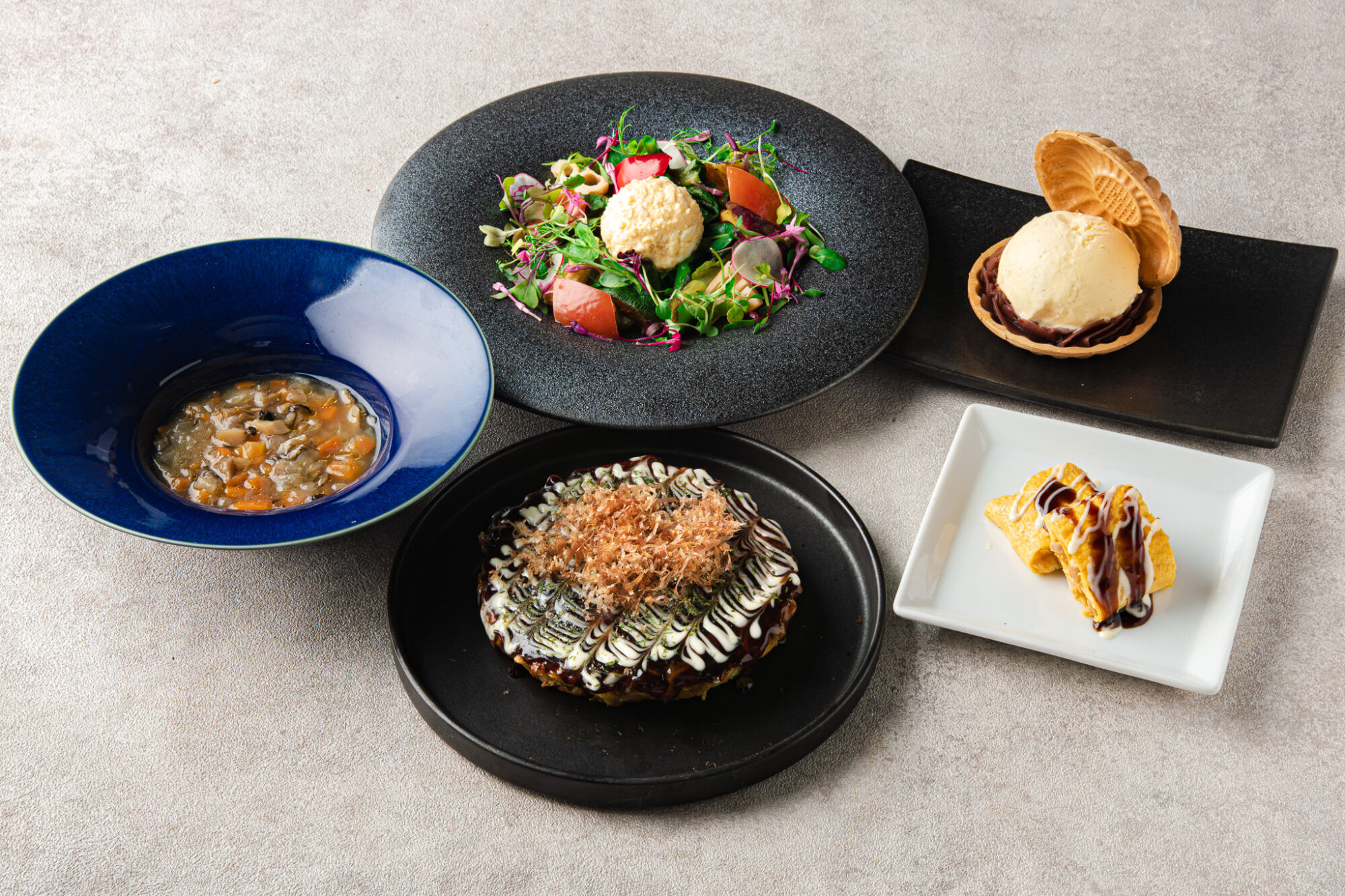 Course spread highlighting steak and plated dishes